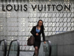 woman-walking-under-louis-vuitton-sign-in-china